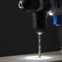Cordless drill with bright LED light illuminating a woodworking drill point for precision accuracy