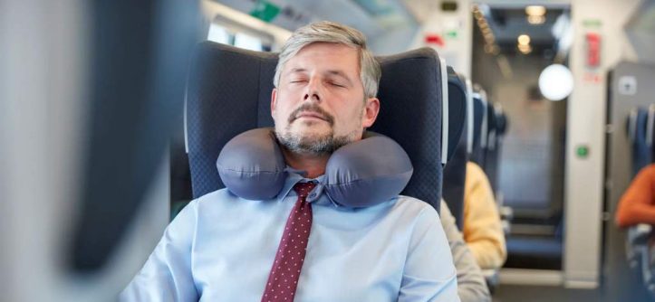 sleeping peacefully on airplane using twisted Dot&Dot memory foam travel pillow around neck
