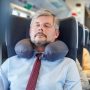 sleeping peacefully on airplane using twisted Dot&Dot memory foam travel pillow around neck
