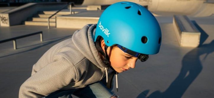 Beginner skater wearing Bavilk multi-sport helmet at skatepark with adjustable fit dial visible