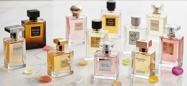 A collection of luxury designer perfume bottles arranged elegantly on a white marble surface in 2026