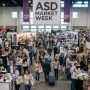 Busy wholesale trade show floor with exhibitor booths and retail buyers at ASD Market Week Las Vegas