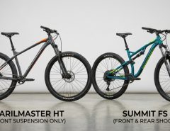 Two entry level mountain bikes standing side by side in a studio.