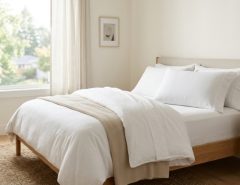 A clean cooling pillowcase resting on a neatly made bed.