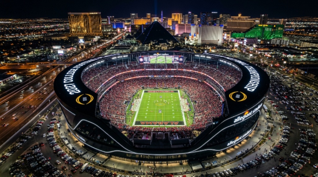Aerial view of Allegiant Stadium in Las Vegas, Nevada, lit up for the 2027 CFP National Championship game on January 25, 2027, with fans filling every seat