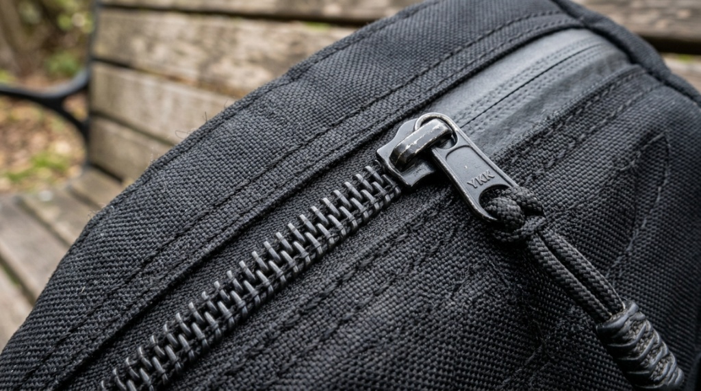 Close-up of heavy-duty fabric and reinforced zippers on a sports backpack.