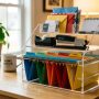 Minimalist wooden desk organizer neatly holding pens, notepads, and sticky notes.