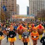 Runners and walkers in festive Thanksgiving costumes at the Strategic Staffing Solutions Turkey Trot 2026 in Downtown Detroit